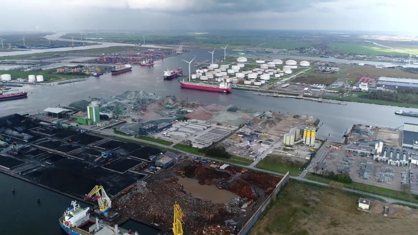 Helicopter view aerial of harbor of Amsterdam showing oil terminal and North Sea Channel in background it is the 4th busiest port in Europe by metric tonnes of cargo and connected to the sea 4k Royalty-Free Stock Footage #1055615645