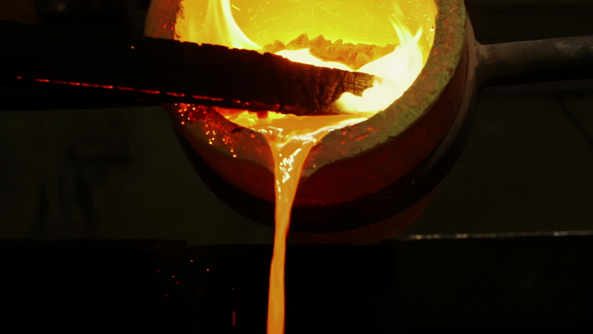 Orange and Yellow Hot Liquid Metal is Pouring to the Gold bar Shape Ingots of Precious Metals Production, non-ferrous metal processing plant. | Shutterstock HD Video #1055623352