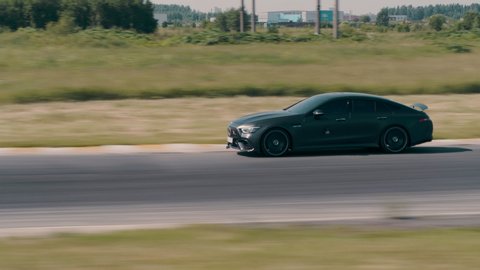 Drone footage of Mercedes-AMG GT63 black car. Hight speed driving on race track. Saint-Petersburg Russia 17.06.2020