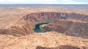 4K aerial video of incredible abstract martian nature landscape with red plateau and curving deep canyon with green river below. Drone flying along Mars planet scenery. Bird view Horseshoe Bend, USA