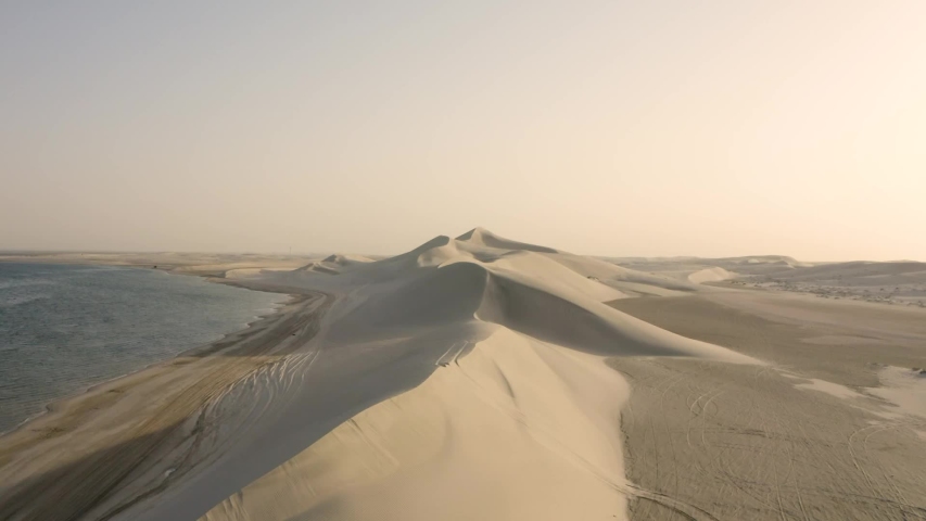 Dolly in of the dunes and shore of Qatar  Royalty-Free Stock Footage #1055629535