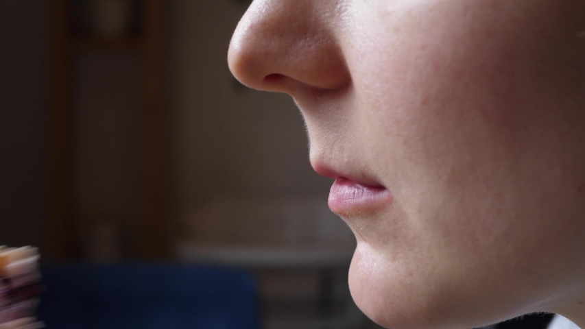 Young Woman Biting Vegan Wrap. Closeup.