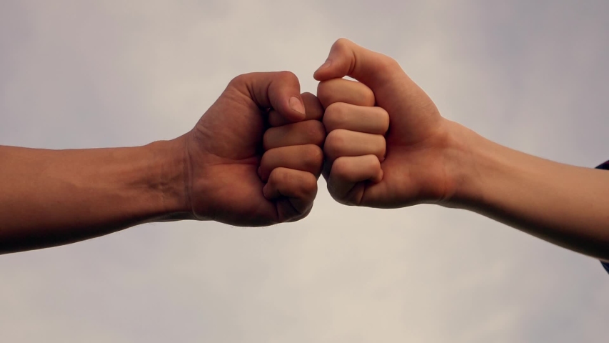 Business concept of teamwork. Close-up of the fists touching the symbol of a successful transaction, cooperation. Two successful people shake hands, a business group handshake.