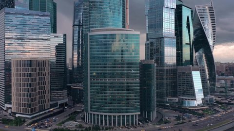 Aerial drone tilt up shot close up of Moscow City glass buildings. Smooth drone shot from the bottom of Moscow Business Center skyscrapers