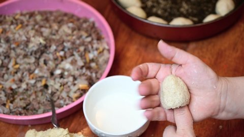 Woman hands making and preparing middle eastern traditional food. Delicious Kibbeh, famous in Arabic country especially in  Lebanon, Syria.