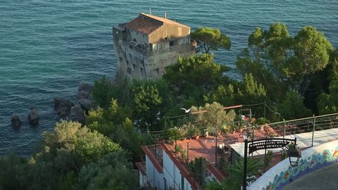 Vietri sul Mare, Italy. July 8th, 2020. View on the Crestarella Tower e the enchanting sea of the town of Vietri at the Amalfi Coast with seagulls flying over.