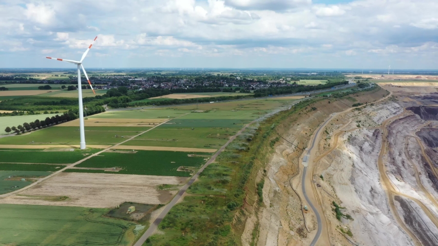 GARZWEILER / GERMANY - 21 June 2020: Pan over the Garzweiler Open Lignite Mining Area near the village of Hochneukirch. Aerial drone shot.
