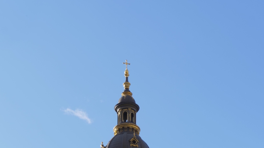 Top of the St. Stephen's Basilica in Budapest with the Holy Golden Cross and Background Cloud, Hungary Royalty-Free Stock Footage #1055653589