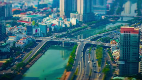 A timelapse of miniature traffic jam at the busy town high angle long shot tiltshift zoom. Ho Chi Minh / Vietnam - 02.26.2020