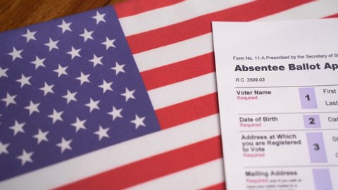 Maski, India - 23, June 2020 : Pan view of Absentee ballot application on US flag for American Presidential elections