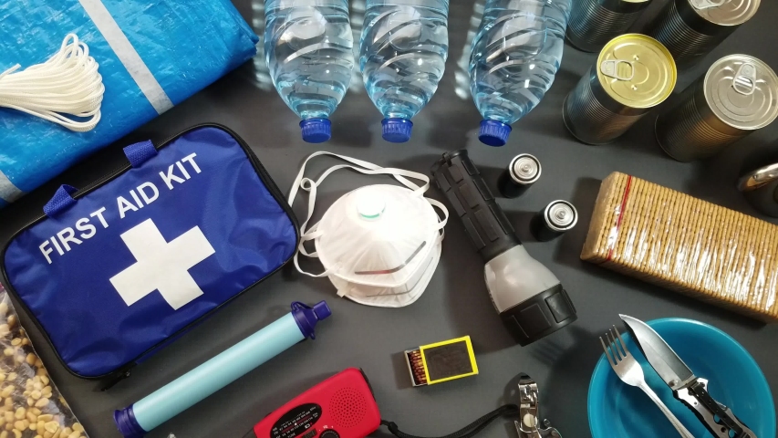 Prepare for a natural disaster by putting together important items that will help you survive. Water, foods, shelter, light source, first aid kit are just a few of the items needed to survive | Shutterstock HD Video #1055674715