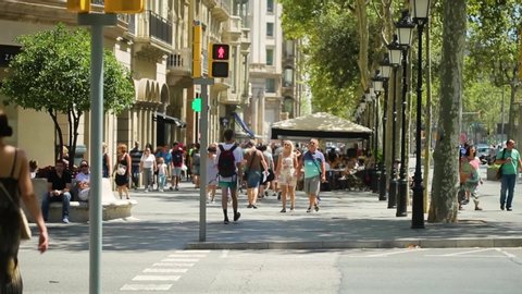 BARCELONA, SPAIN - AUGUST 6, 2016: Tourists crossing a traffic light on a famous Barcelona street, on August 6, 2016 in Barcelona Spain, on August 6, 2016 in Barcelona Spain