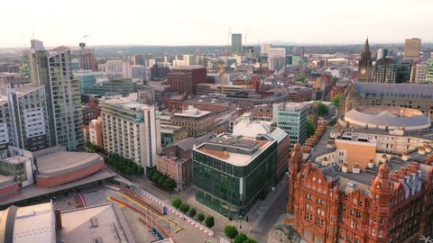Flyover aerial shot of center of Manchester with totally empty streets during the dawn