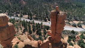 4K circular drone flight around marvelous red spire-shaped rock formation hoodoo at Bryce canyon, Utah. Scenic aerial view on the nature amphitheater in beautiful landscape. Travel USA video