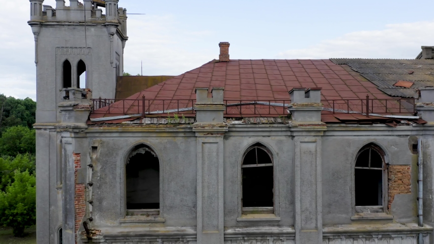 Abandoned 19th century palace  (manor or mansion house) with broken windows in Neo-Gothic (Gothic Revival) style. Aerial view.  