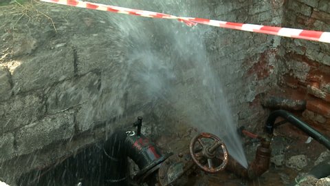 Water flows from a rusty water pipe. Water accident