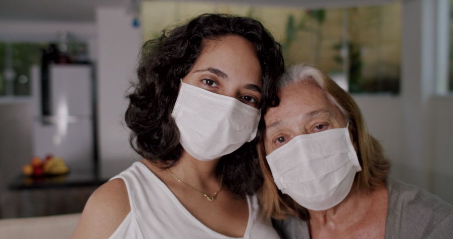 Portrait of Woman and Elderly Senior Together Wearing Face Mask | Shutterstock HD Video #1055700356