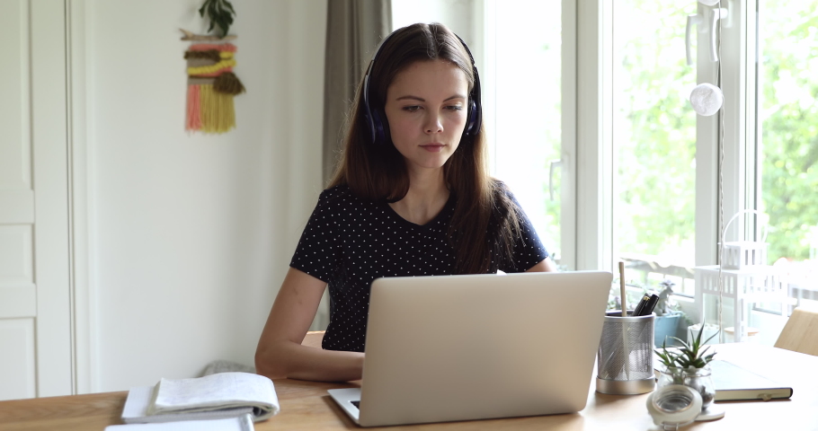 Teenage student girl wear headphones using laptop seated at desk received e-mail feels very happy. Great news, scholarship acceptance, entrance exams admission examinations pass successfully concept Royalty-Free Stock Footage #1055702660