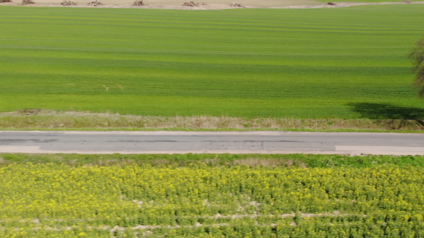 Delivery Van. Postal Delivery Service. Aerial View Shot of Car riding Through Empty Rural Road. Road on Countryside. Truck Driving Through Beautiful Suburban. Aerial View Spring Agricultural Fields. Royalty-Free Stock Footage #1055707238
