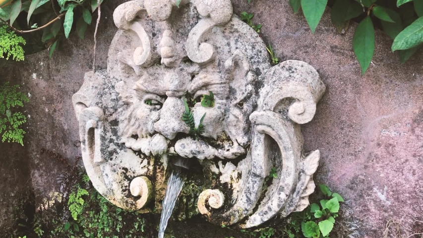 Maschera Zeus statue fountain in Funchal, Madeira. Handheld travelling shot.