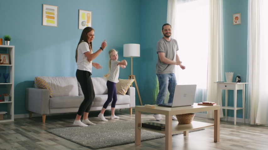 Young family is dancing at home, having fun, spend weekend morning actively, enjoy their common hobby, concept of happiness and joy, Slow motion. Royalty-Free Stock Footage #1055725151