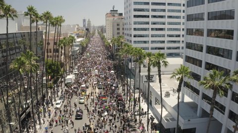 Los Angeles , California / United States - 06 14 2020: Massive All Black Lives Matter Protesting March, Hollywood Boulevard. Tilt Up Aerial View of People With LGBTQ Community Asking For Equal Human C