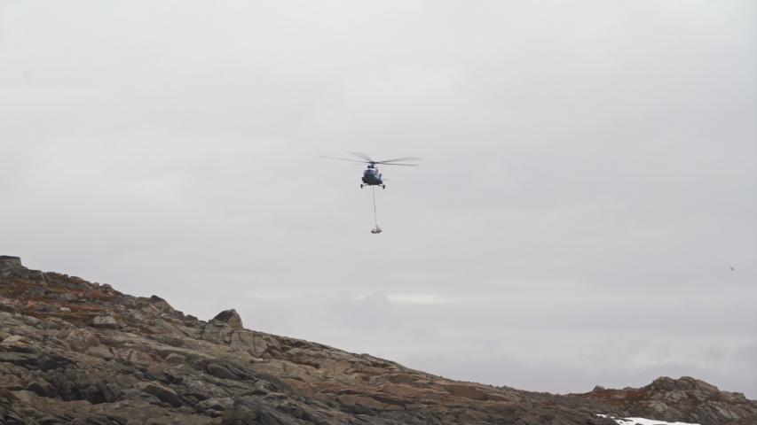 MI8 helicopter carries cargo on the sling