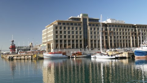 CAPE TOWN, SOUTH AFRICA CIRCA JULY 2020, VA Waterfront, pan Clock tower, office buildings, boat marina to Zeitz Museum of Contemporary Art Africa - all quiet with no people during Covid 19 travel ban