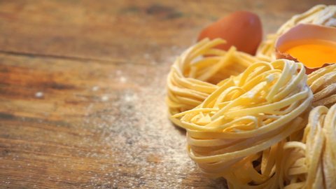 Fresh pasta on a wooden background. Homemade Italian pasta made from flour and eggs for dishes of Italian food and cuisine