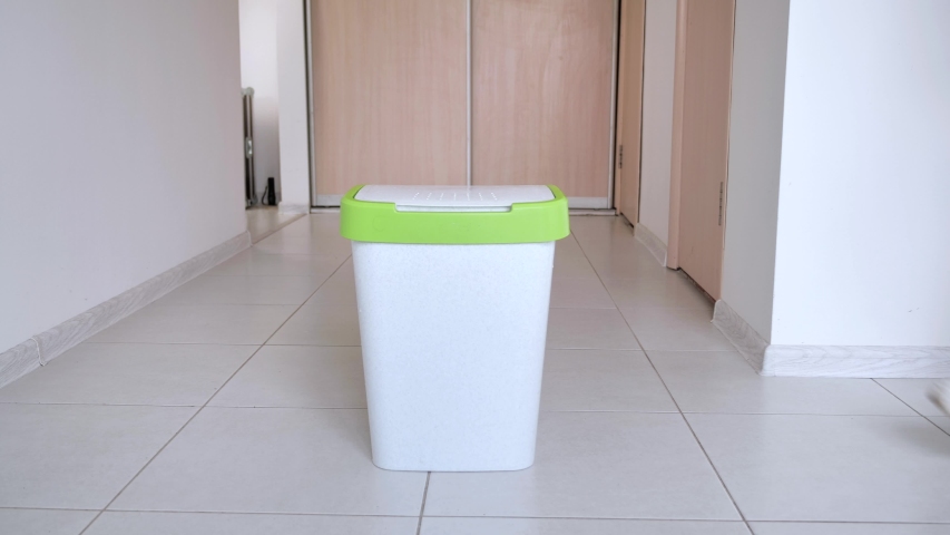 Close-up of woman  throws trash into the  bin at kitchen. Royalty-Free Stock Footage #1055762564