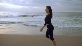 Asian woman runs happy on the beach, sporty Asian girl runs on the sea at sunset, sports run, slow motion video