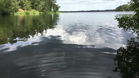 Nice view over dark cold water a summer day. Sweden, 2020.