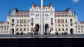 Amazing video about the hungarian parliament building. Clear blue sky with clouds. Fantastic touristic destination in Budapest Hungary. You can you see a guard of honor.