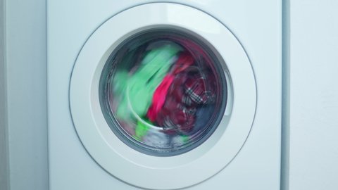 Spinning drum of a washing machine with casual clothes. Laundry day