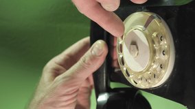 Dialing the rotary dial of the vintage telephone inside the house.Vertical Screen Orientation Video 9:16