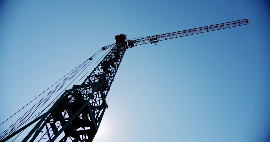 Crane rotate at building construction site, architecture apartments. Wide shot V4