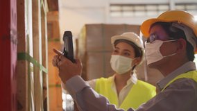 Asian female worker talking with manager in warehouse store. Woman and man engineers people wear safety hard helmet, vest and face mask checking storage box parcel in factory during covid 19 pandemic. - Powered by Shutterstock - Get 15% off with code: PIKWIZARD15