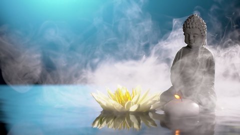 Buddha Statue,burning candle and water lily in water