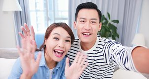 Asian couple has video chat with their friend happily