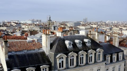 Church of Notre Dame in Bordeaux France along with the dome of Les Grands Hommes commercial center, Aerial pedestal reveal shot