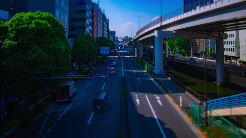 A timelapse of miniature downtown street at Sotobori avenue wide shot tiltshift. Shinjuku district Tokyo Japan - 06.08.2020 : It is a center of the city in tokyo.