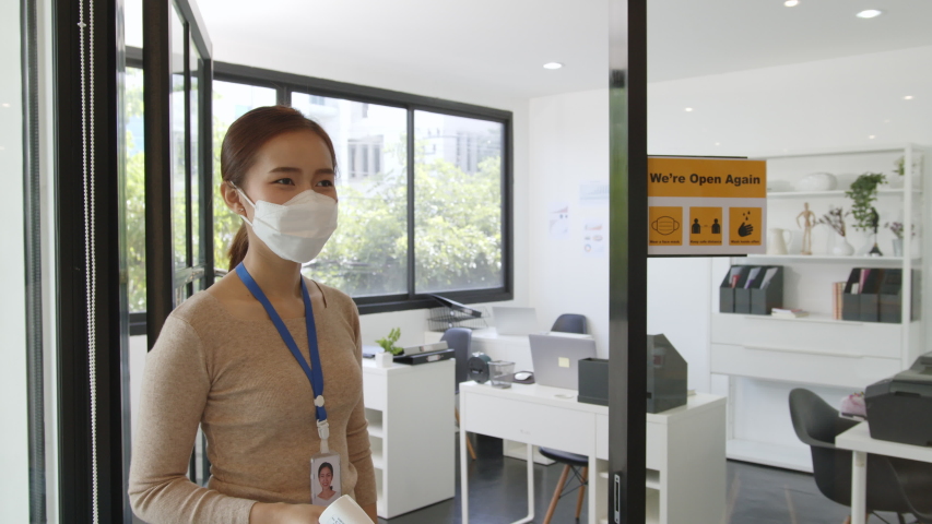 Asian businesswoman wear protective face mask using infrared thermometer check temperature of working people before enter ing office, reopen business with new normal and social distancing concept Royalty-Free Stock Footage #1055830133