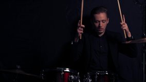 Talented guy play on drums, preparing for concert, rock and roll performer.