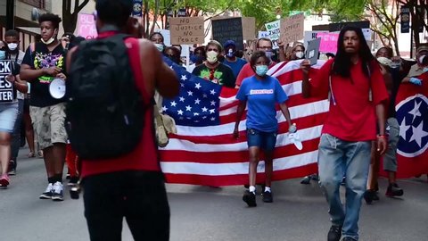 CIRCA 2020 - Black Lives Matter protesters march through the streets of Nashville Tennessee, during a BLM rally.