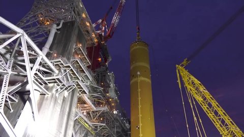 CIRCA 2020 - NASA the first core stage of a rocket being erected at the Stennis Space Center.