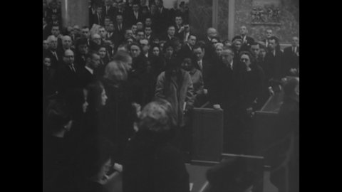 CIRCA 1963 - Jackie, Caroline, and John F. Kennedy Jr. enter the crowded St. Matthew's Cathedral in Washington DC ahead of JFK's casket.