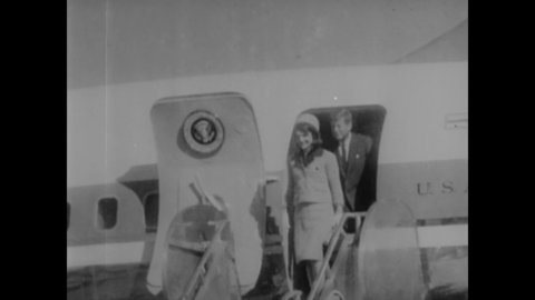 CIRCA 1963 - JFK and Jackie Kennedy are rapturously received at the airport in Dallas, Texas, and the motorcade gets underway.