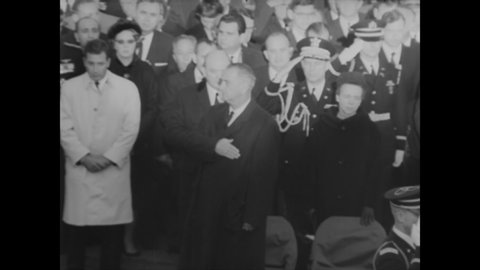 CIRCA 1963 - LBJ and President de Gaulle are seen among the crowd saluting at Arlington National Cemetery as servicemen fold the flag.