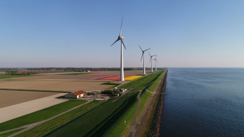 WS AERIAL POV PAN Agricultural fields and wind turbines in polders / Urk, Flevoland, Netherlands