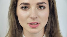 Close up portrait of an attractive teen female opening her eyes and smiling 4k